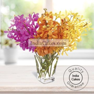 10 EXQUISITE ORCHIDS ARRANGED WITH A GLASS VASE