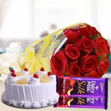 Eggless Half Kg Pineapple Cake with 6 Red Roses Bunch and 2 Cadbury Silk Chocolates