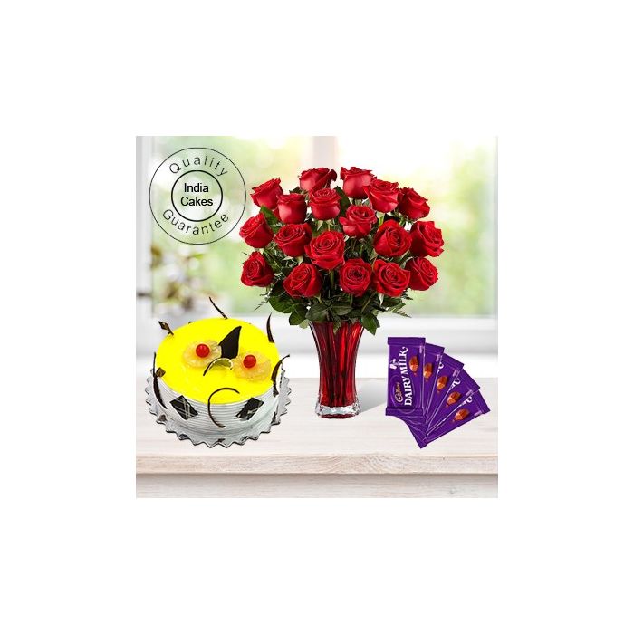 Eggless Pineapple Cake 1.5 Kg with 6 Red Roses Bunch and 5 Chocolates Eggless Pineapple Cake 1.5 Kg with 6 Red Roses Bunch and 5 Chocolates